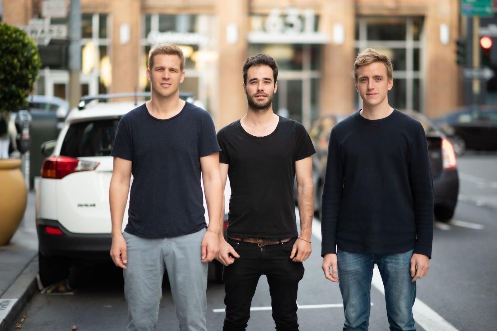 Kyte co-founders Ludwig Schoenack, Nikolaus Volk and Francesco Wiedemann standing beside parked cars in San Francisco