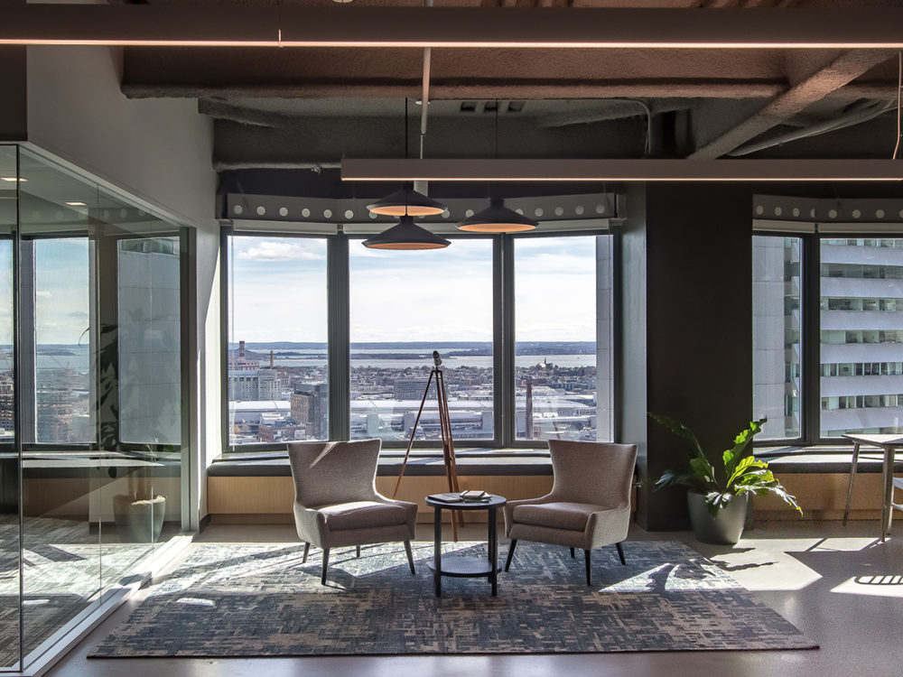 Workable office seating area with large windows and a city view