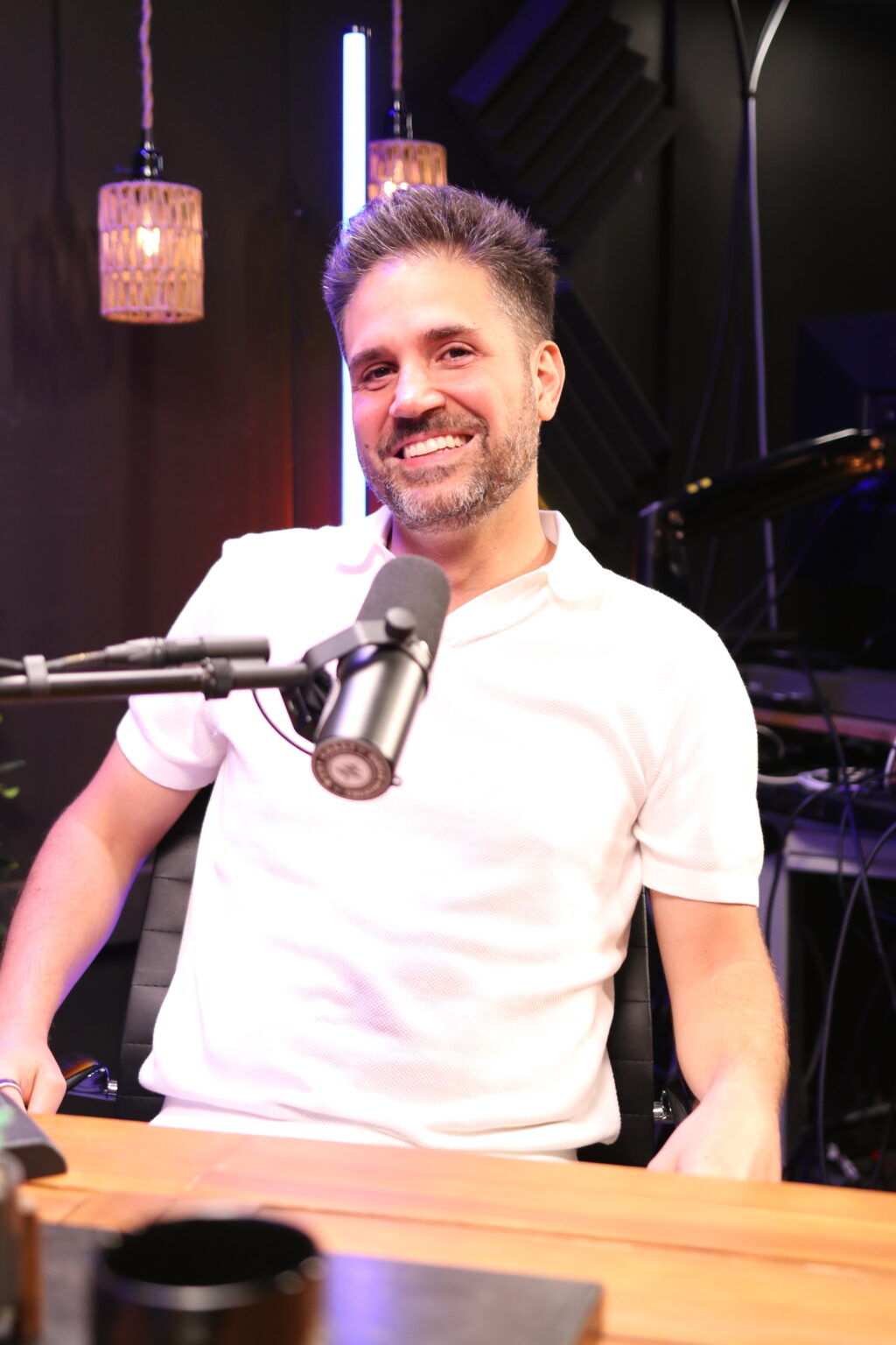Nima Hakimi seated at a microphone during a Closers Club podcast recording