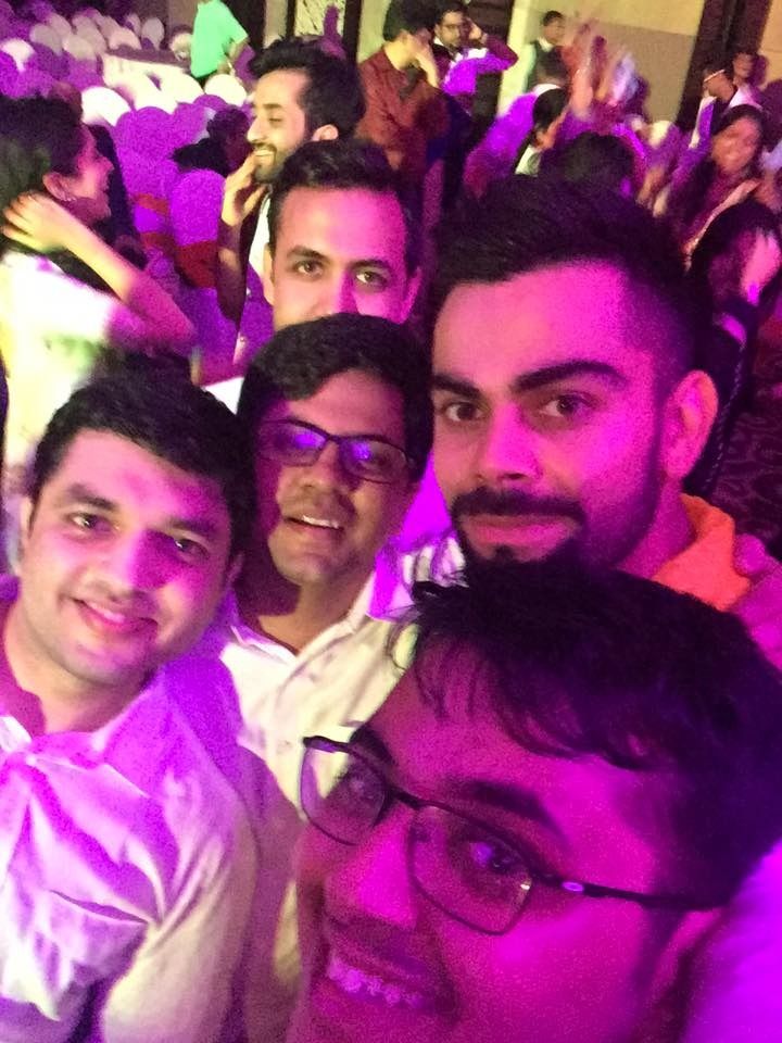 Nimish Goel taking a group selfie with Virat Kohli at a wedding