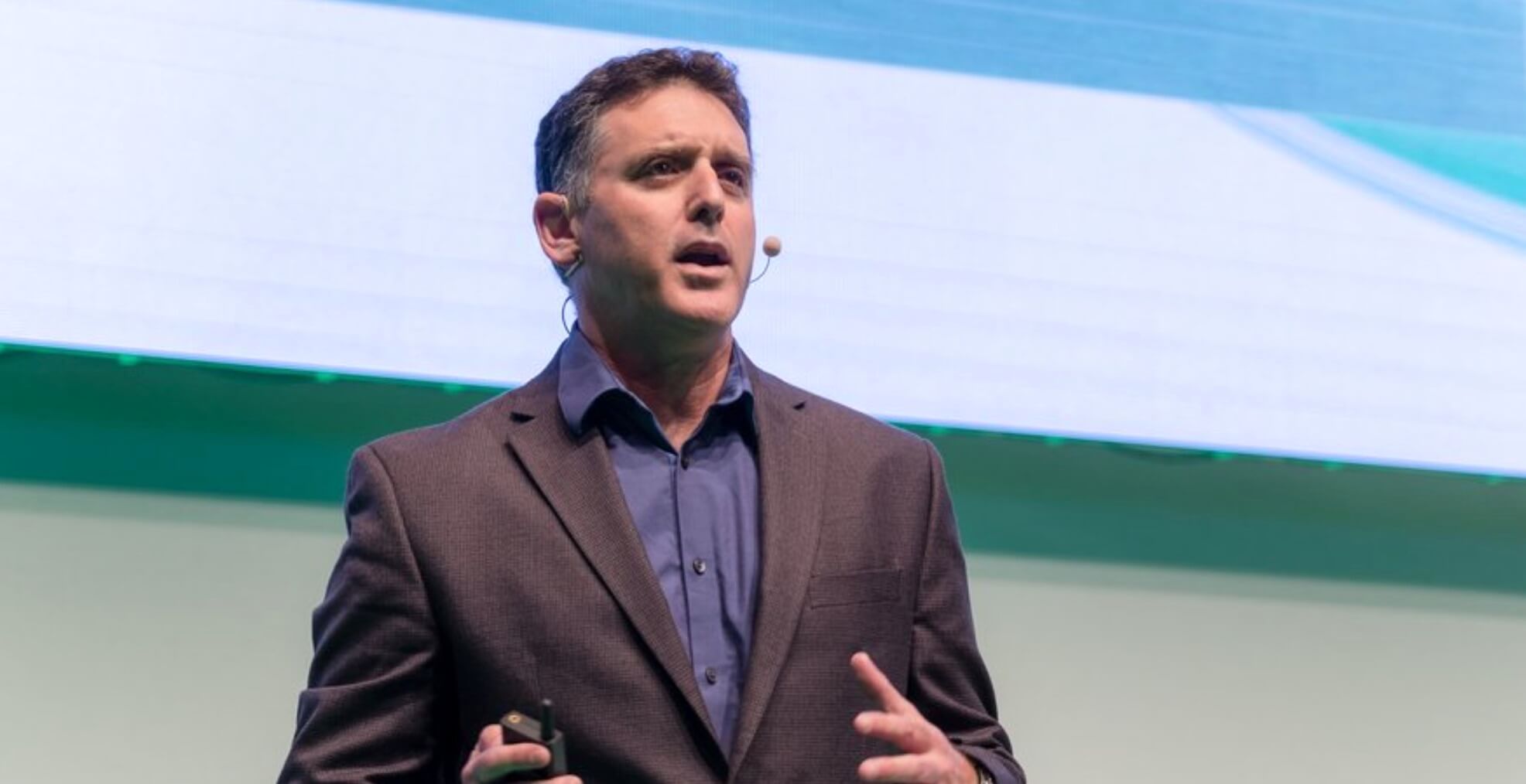 Nir Erez speaking onstage at the NOAH conference in Berlin in 2018