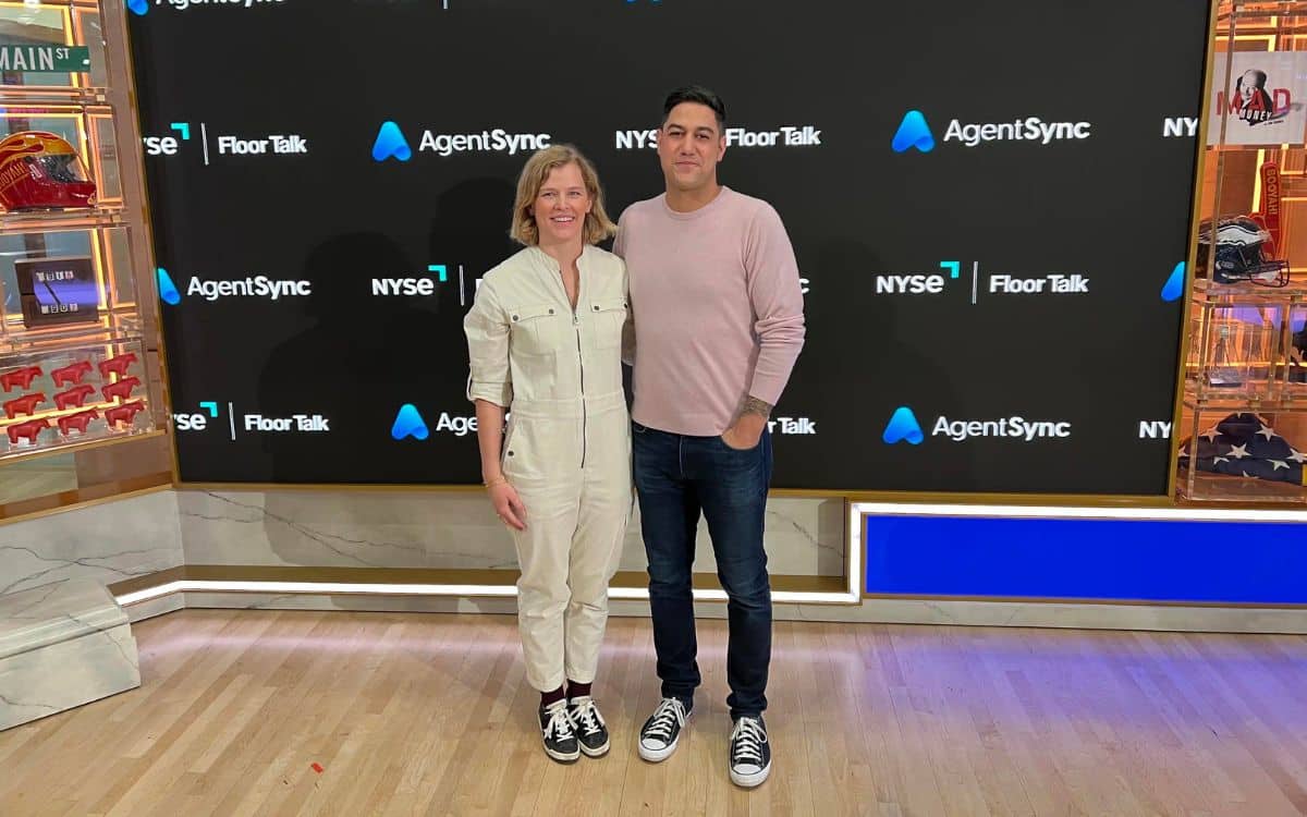 AgentSync cofounders Jenn Knight and Niji Sabharwal standing at the New York Stock Exchange Floor Talk set
