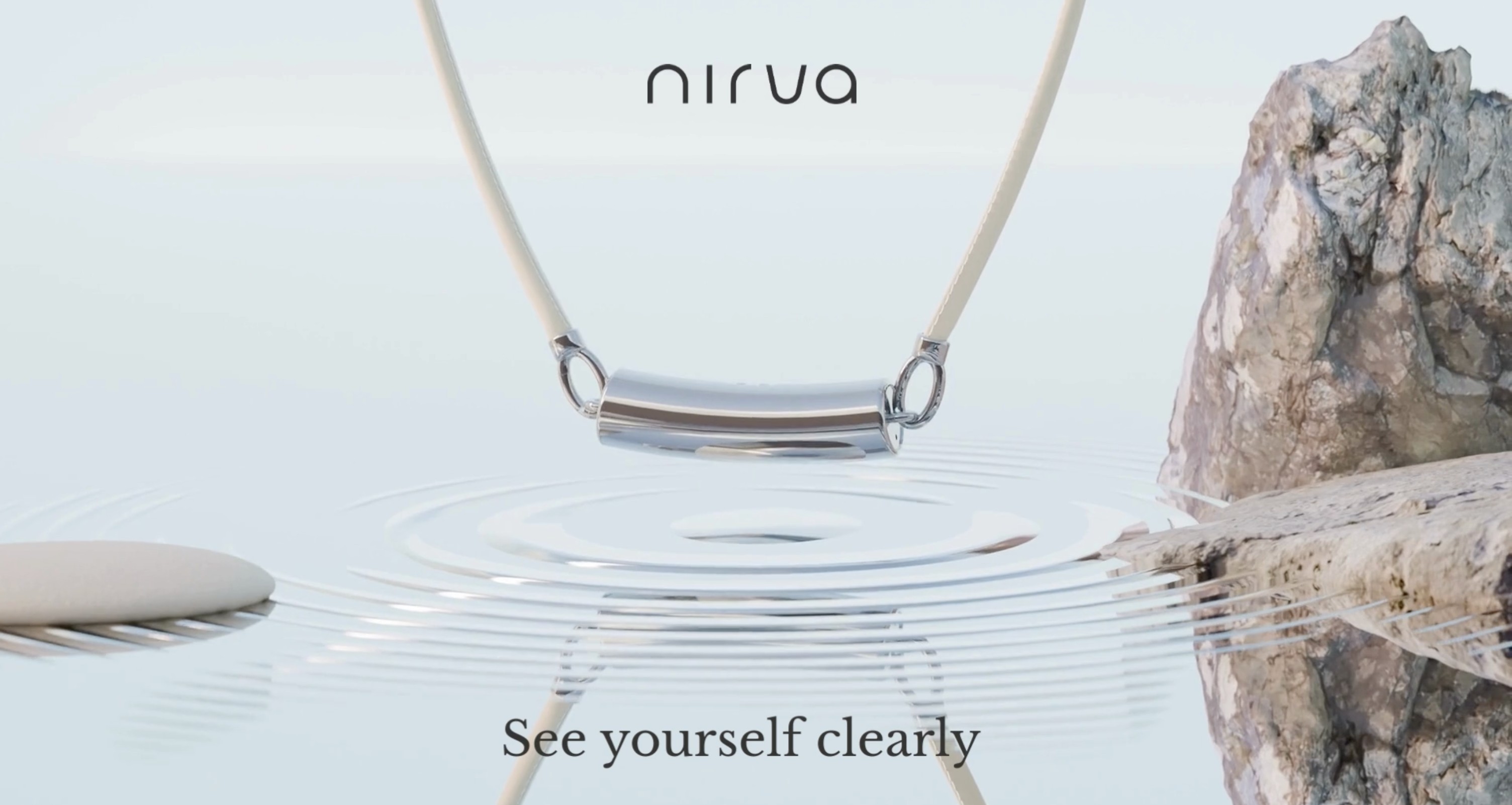 The Nirva AI necklace suspended over still water, with ripples spreading beneath it