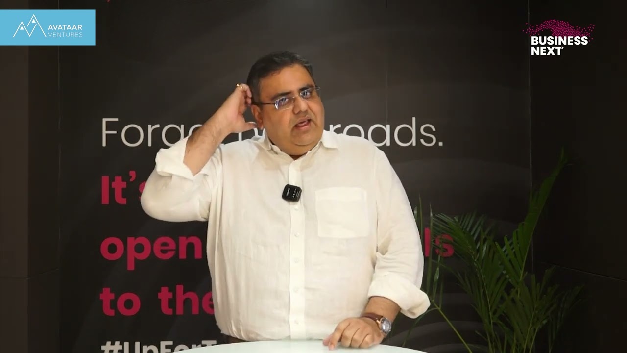 Nishant Singh speaking in an Avataar Ventures video interview, wearing a white shirt and gesturing beside his head