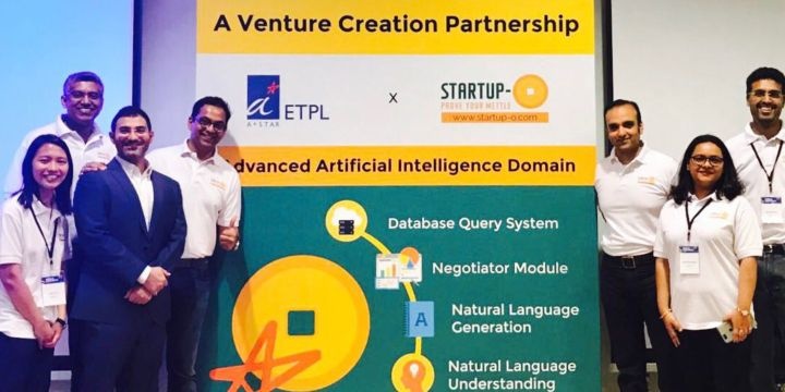 Startup-O partnership group beside a display describing a venture creation partnership with A*STAR ETPL; Nitin Nath stands to the right of the display.