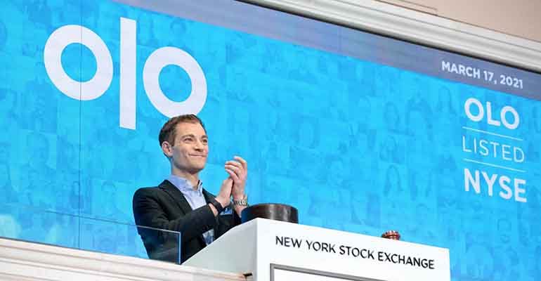 Noah Glass applauds at the NYSE podium on Olo’s March 17, 2021 listing day.