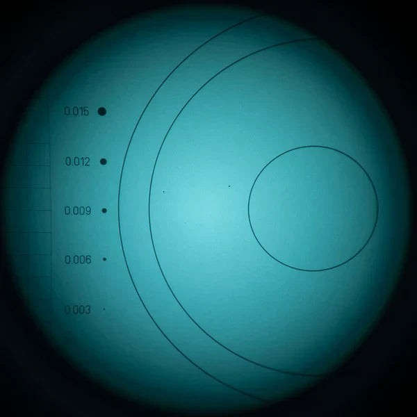 View through a night vision tube showing a resolution test target in green-blue phosphor