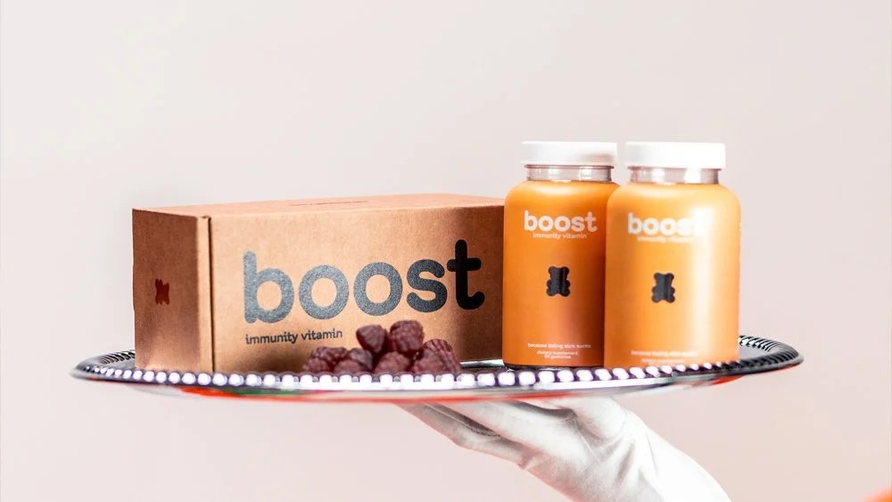 BOOST vitamin bottles and packaging displayed on a silver serving tray
