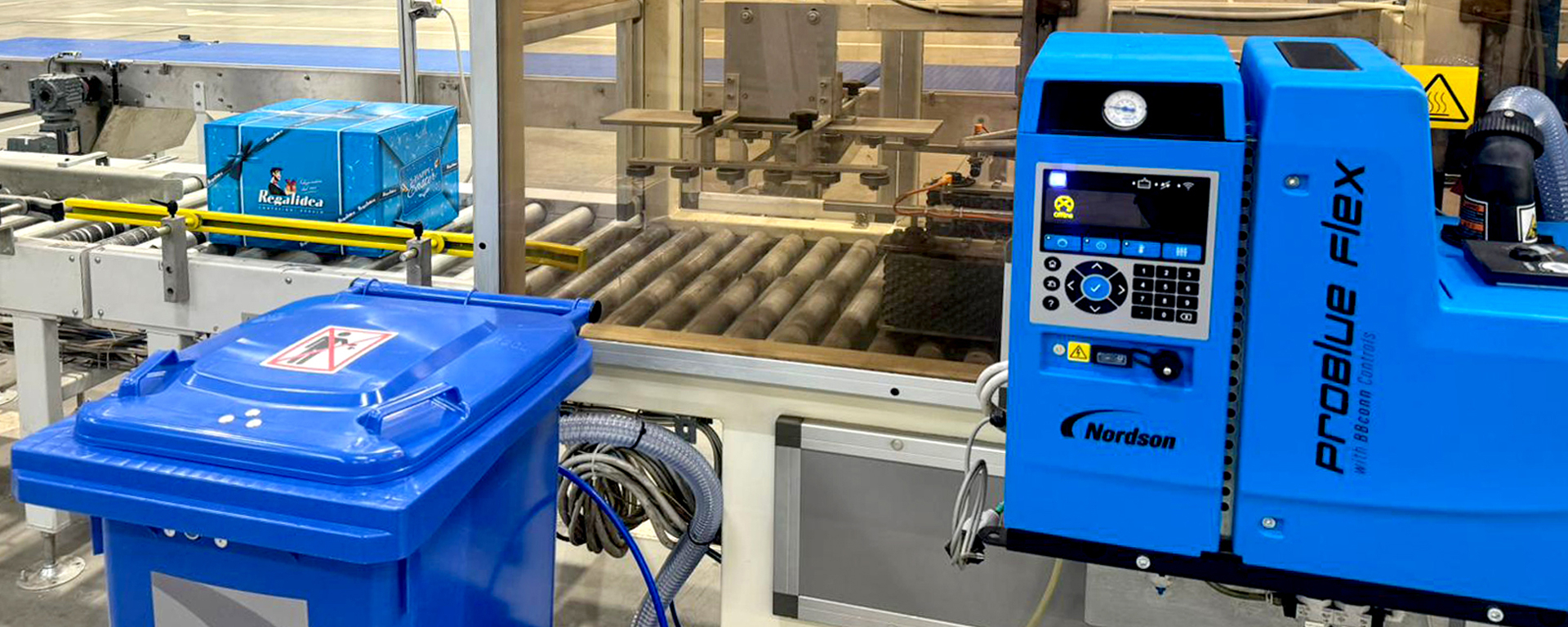Nordson adhesive equipment installed beside Drink International’s packaging conveyor