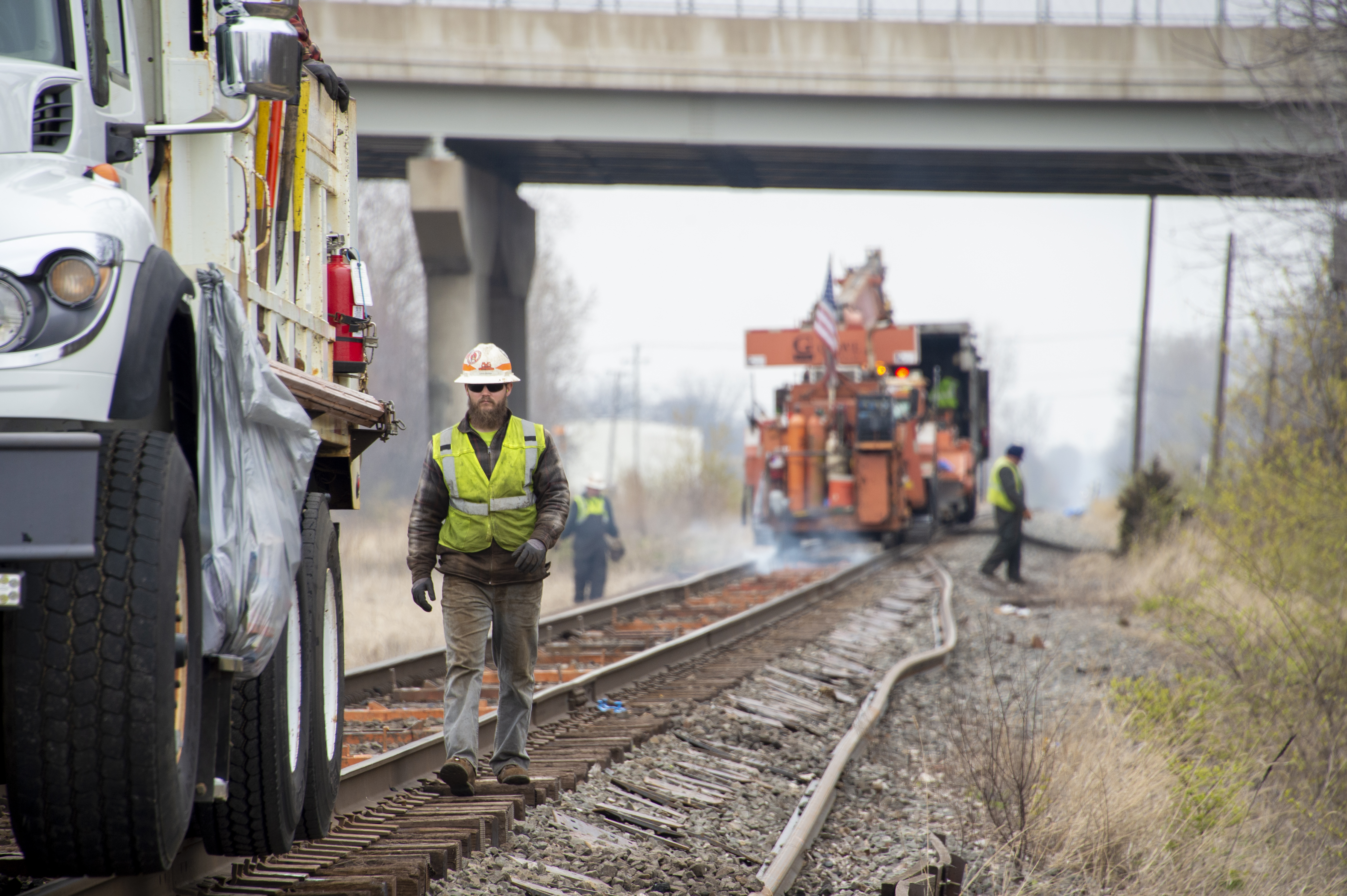 Norfolk Southern track maintenance workers beside rail equipment in Toledo, Ohio