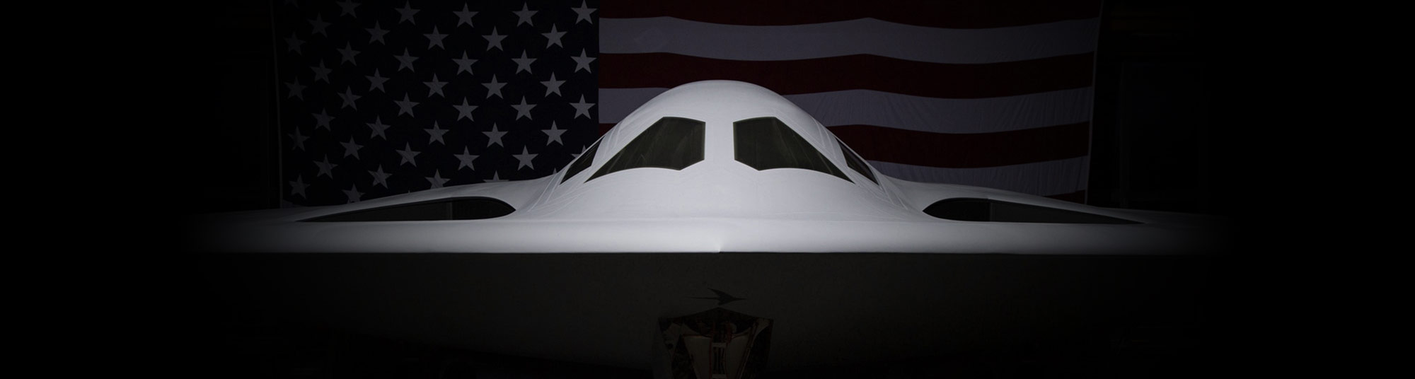 B-21 Raider seen head-on against a dark background