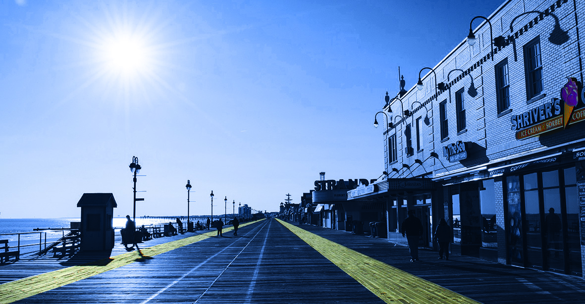 A New Jersey boardwalk lined with businesses beside the ocean