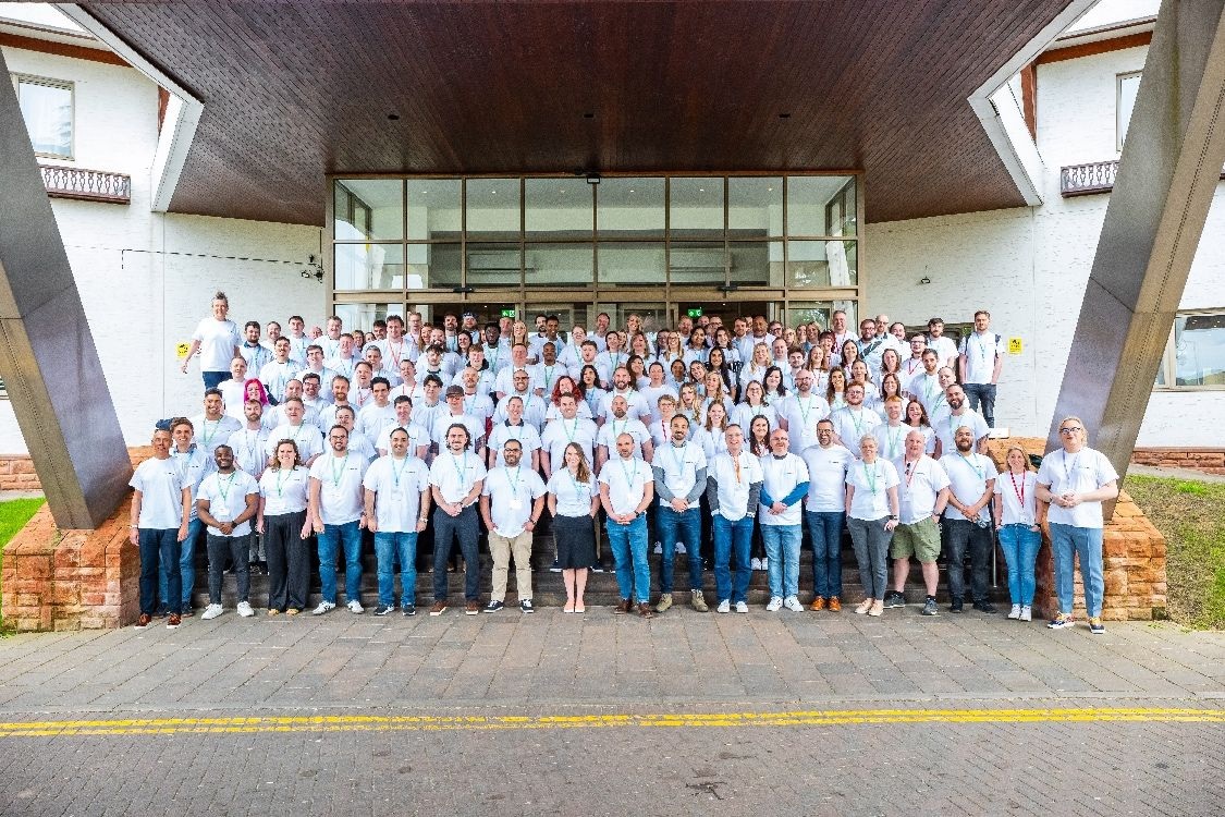A large group of Nourish employees gathered outside a hotel entrance
