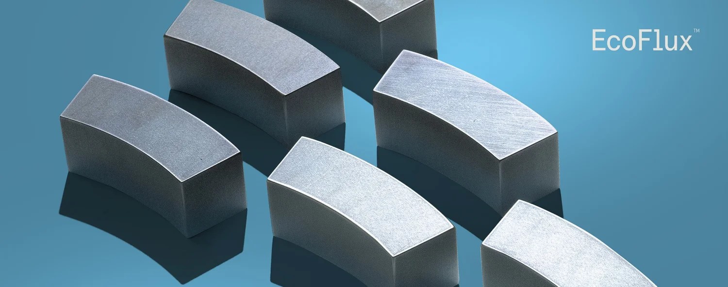 Curved EcoFlux magnet blocks arranged against a blue background