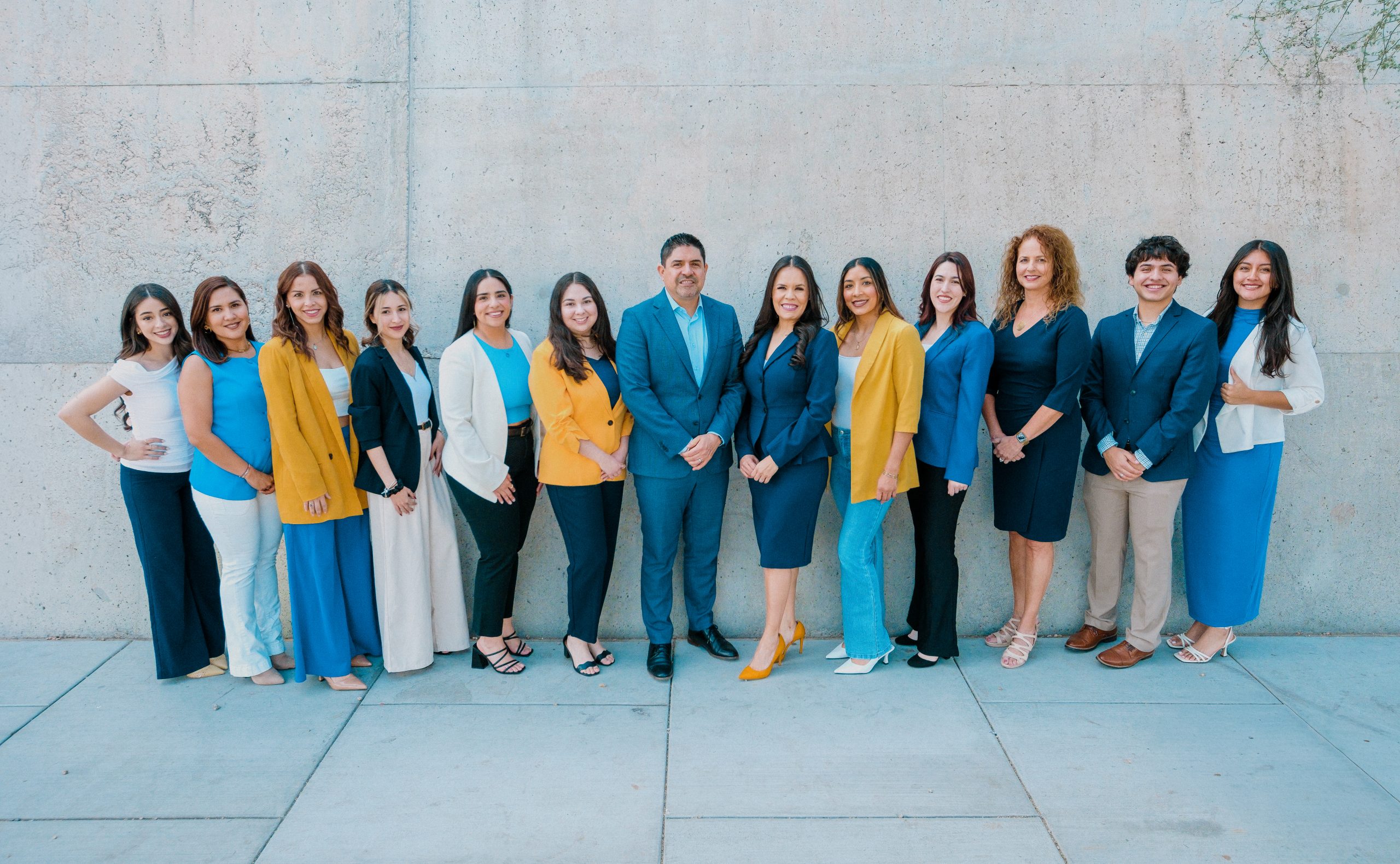 The Novle team standing together in coordinated blue, yellow and white clothing