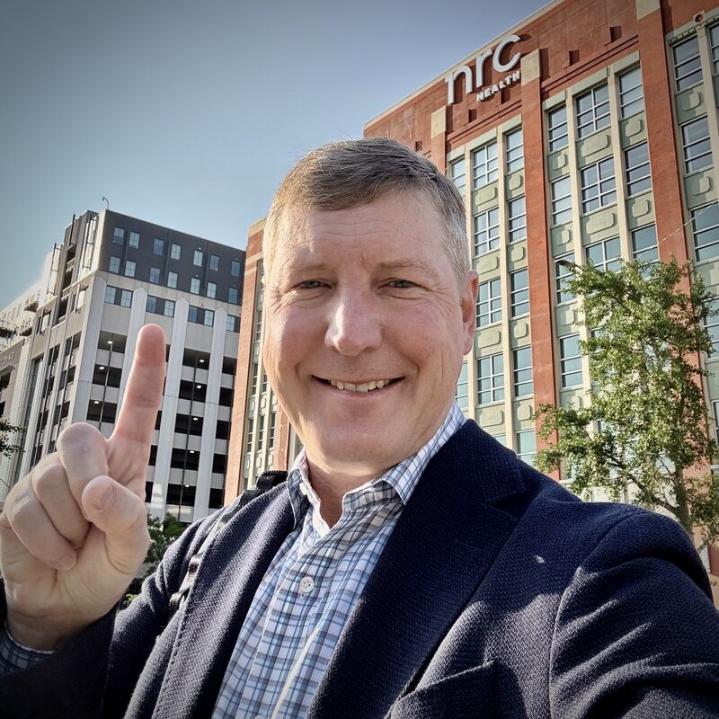 NRC Health CEO Trent Green taking a selfie outside the company’s Lincoln headquarters