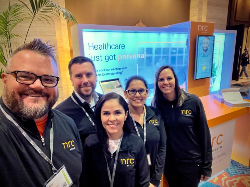 Five NRC Health associates gathered at the company’s ElevatePX conference booth
