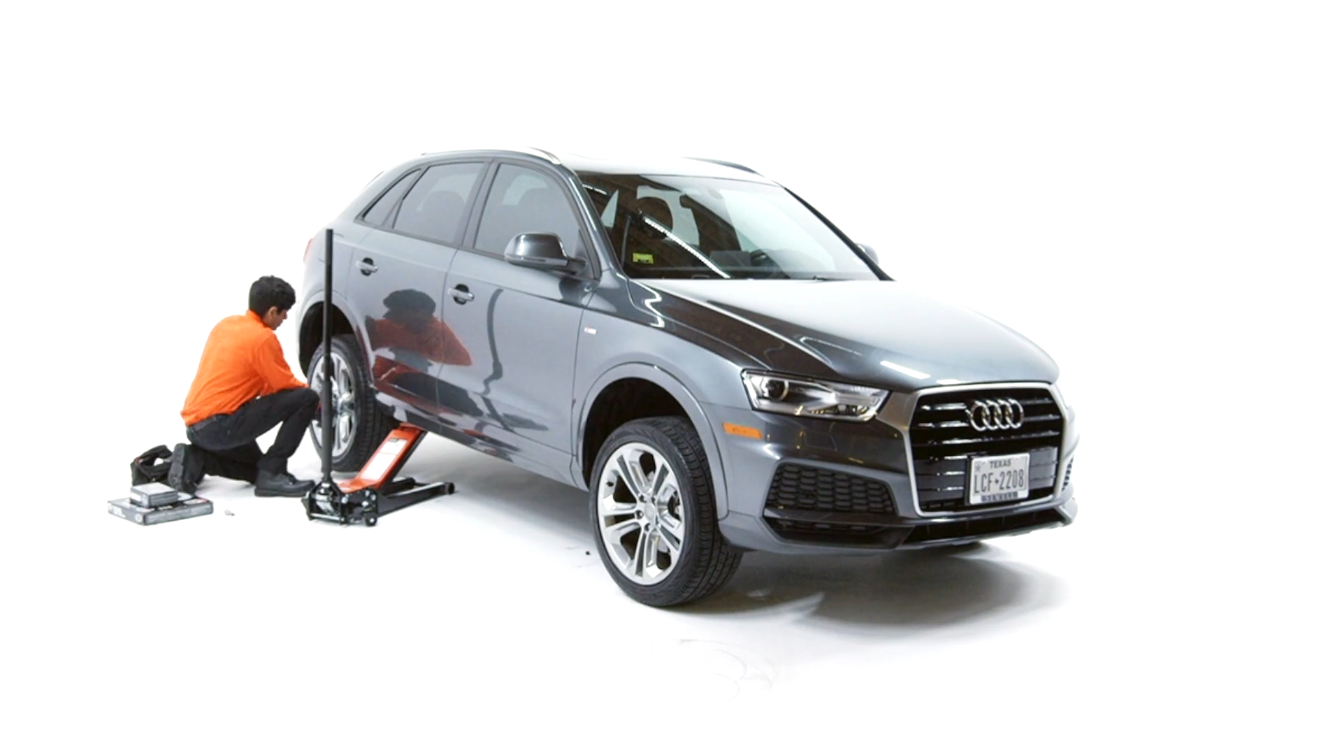 NuBrakes service image showing a technician working beside an Audi