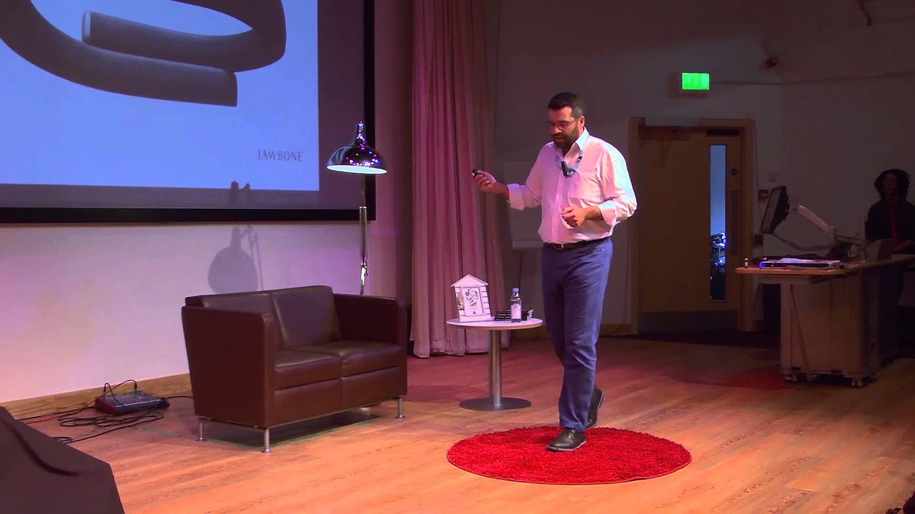Nuno Almeida presenting on a red circular rug at TEDxBournemouthUniversity