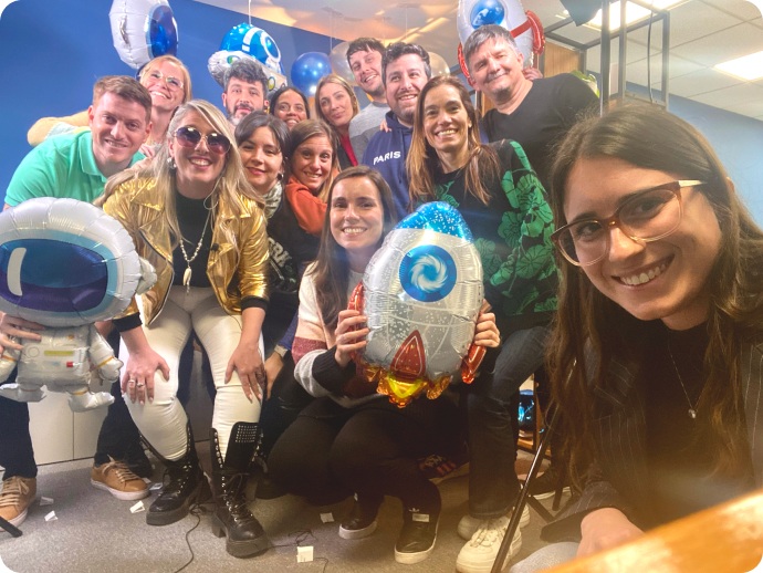 Nybble team members gathered with astronaut and rocket balloons