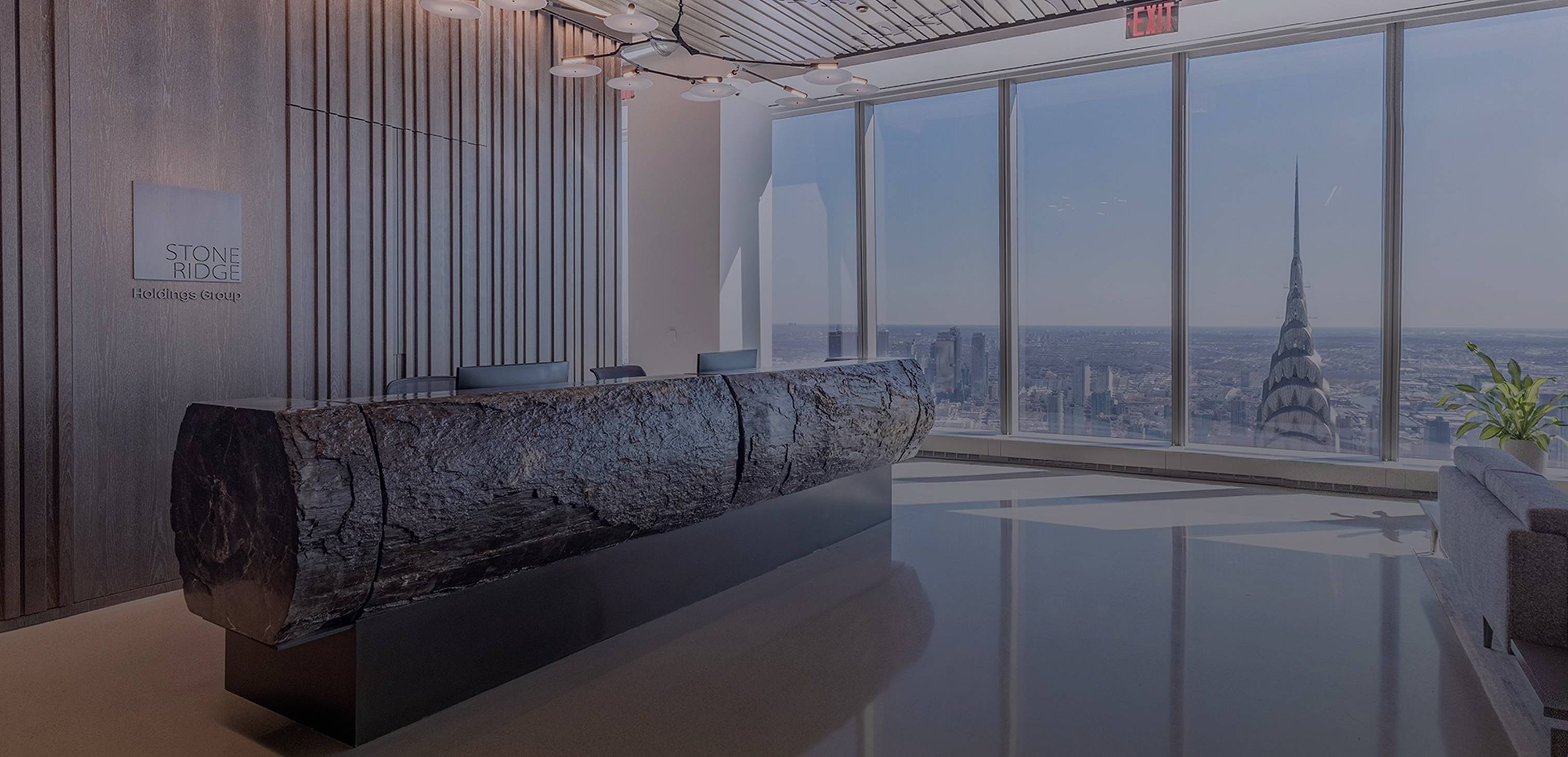 Stone Ridge Holdings Group reception with a dark stone desk and a view across Manhattan