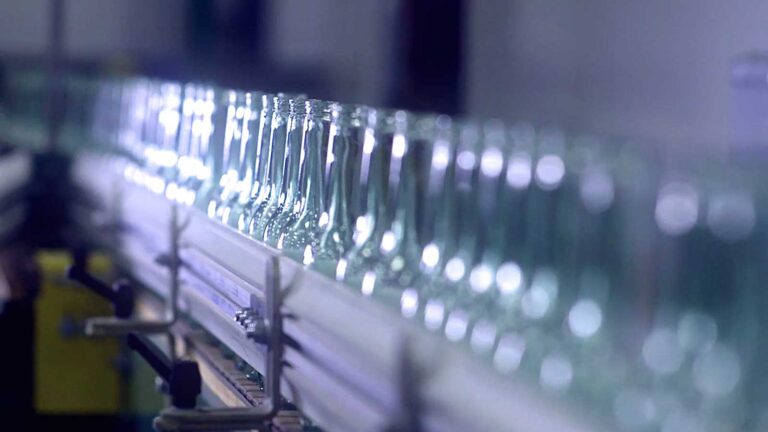 Clear glass bottles on an O-I production line