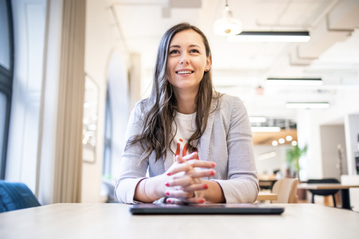 Oana Manolache speaking during an interview in a bright office