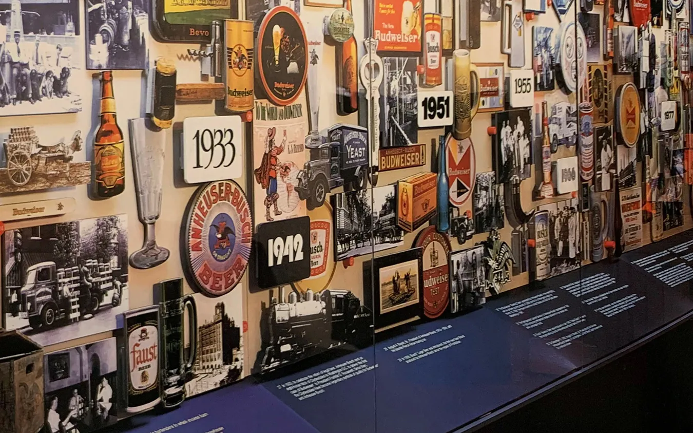 A historical exhibition wall showing beer packaging and advertising created across decades