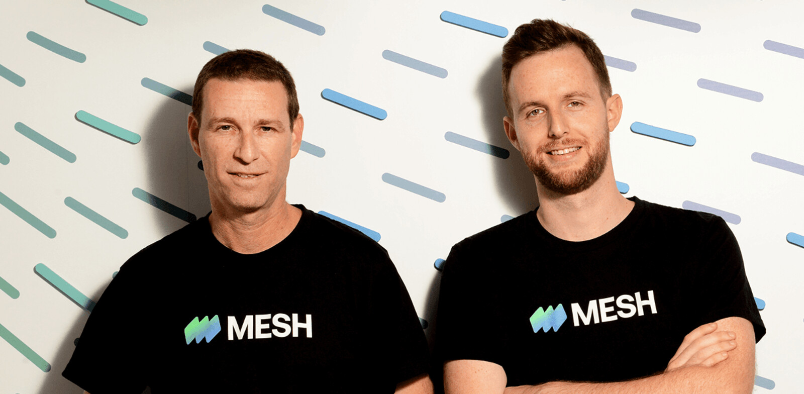 Mesh co-founders Oded Zehavi and Eran Katoni standing together in Mesh shirts