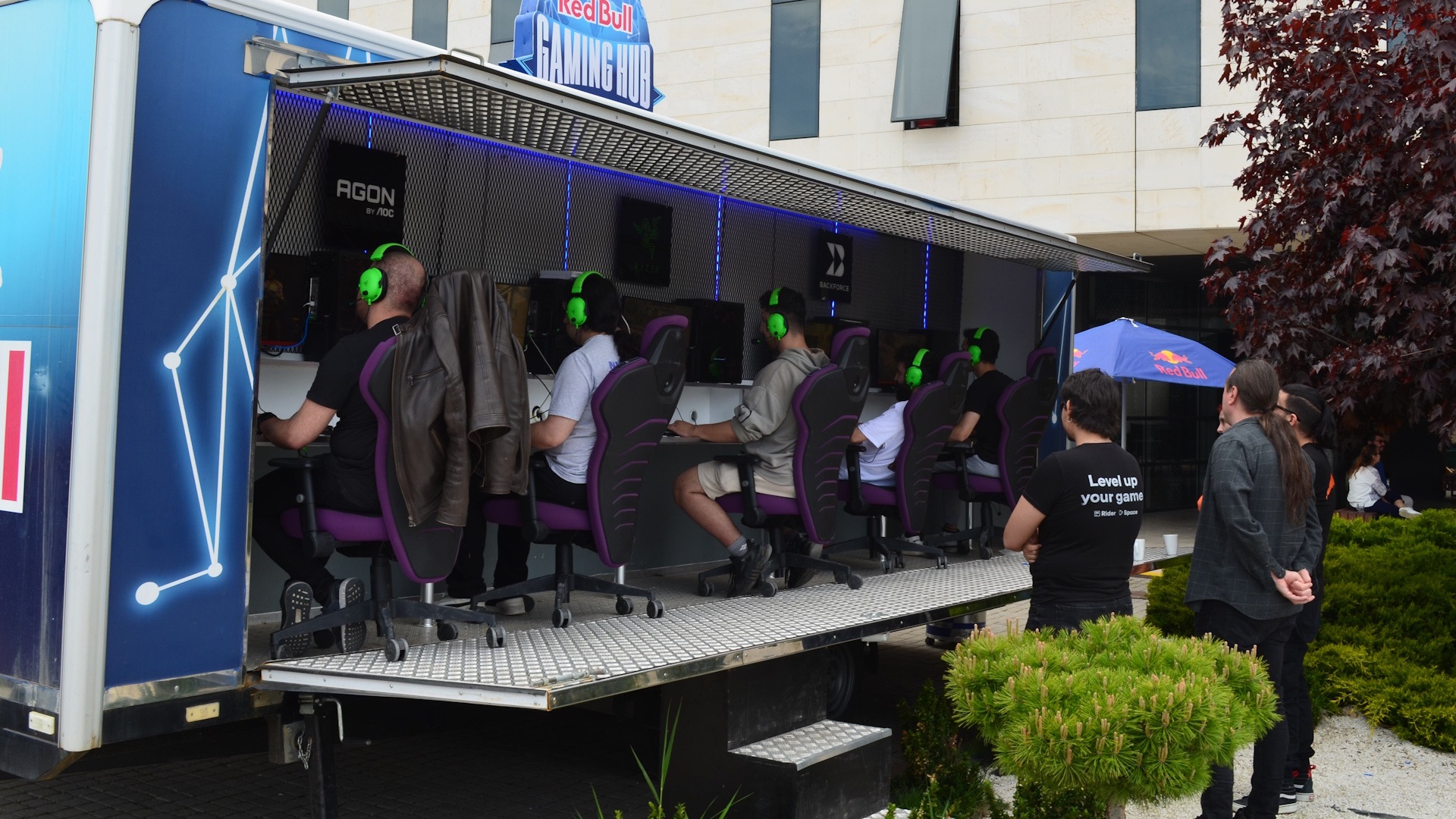 Participants play computer games at a mobile gaming station in a photograph published by ATOM