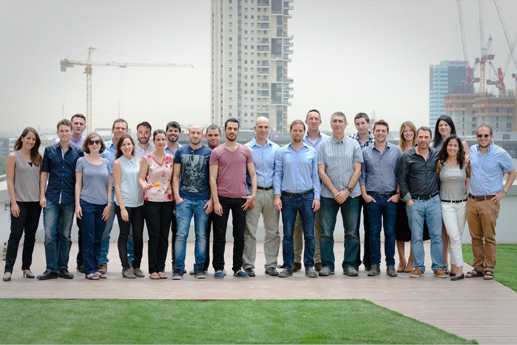 Illusive Networks team gathered outdoors against a city skyline