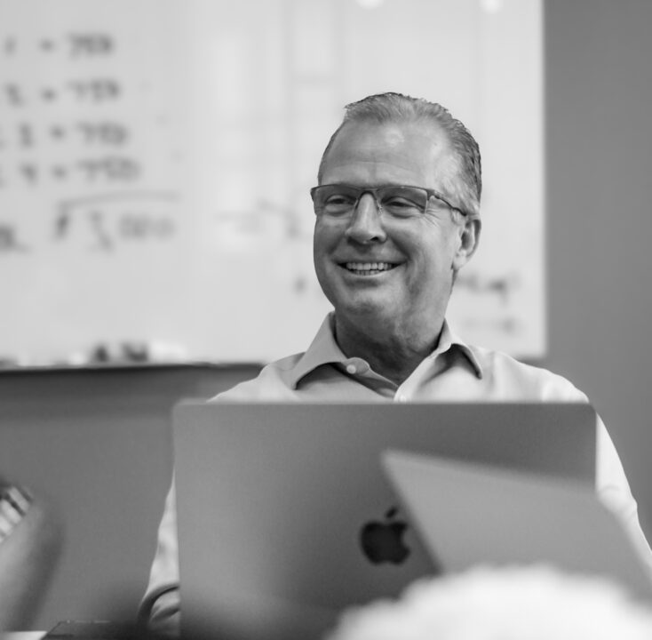 Off Madison Ave co-founder David Anderson seated with a laptop