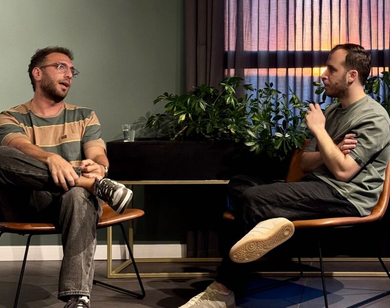 Ofir Bokobza seated in conversation with another speaker