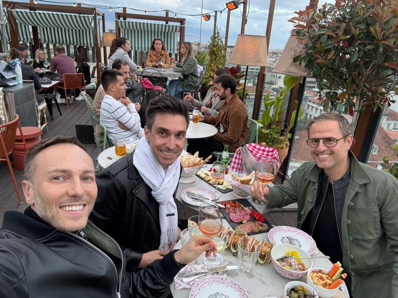 Ofir Ejnes, at right, raising a glass with companions at an outdoor restaurant during an Elfie celebration