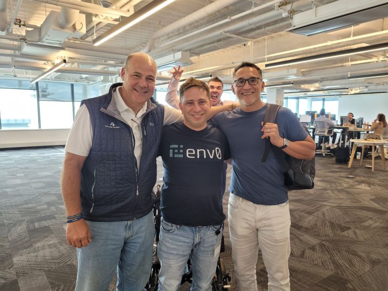 Ohad Maislish with Benjamin Nye and Ed Sim, while Steve Corndell gestures behind them in an office