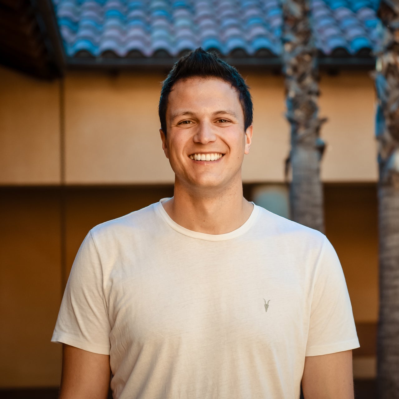 Ohi co-founder Ben Jones smiling in a white T-shirt
