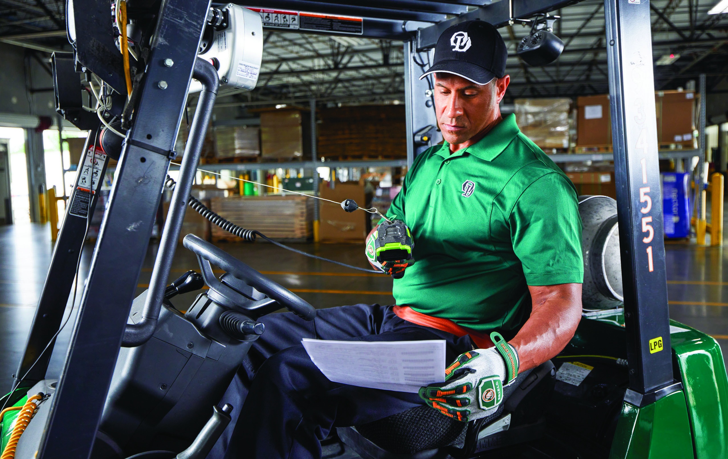 An Old Dominion dock employee checks paperwork while seated on a forklift