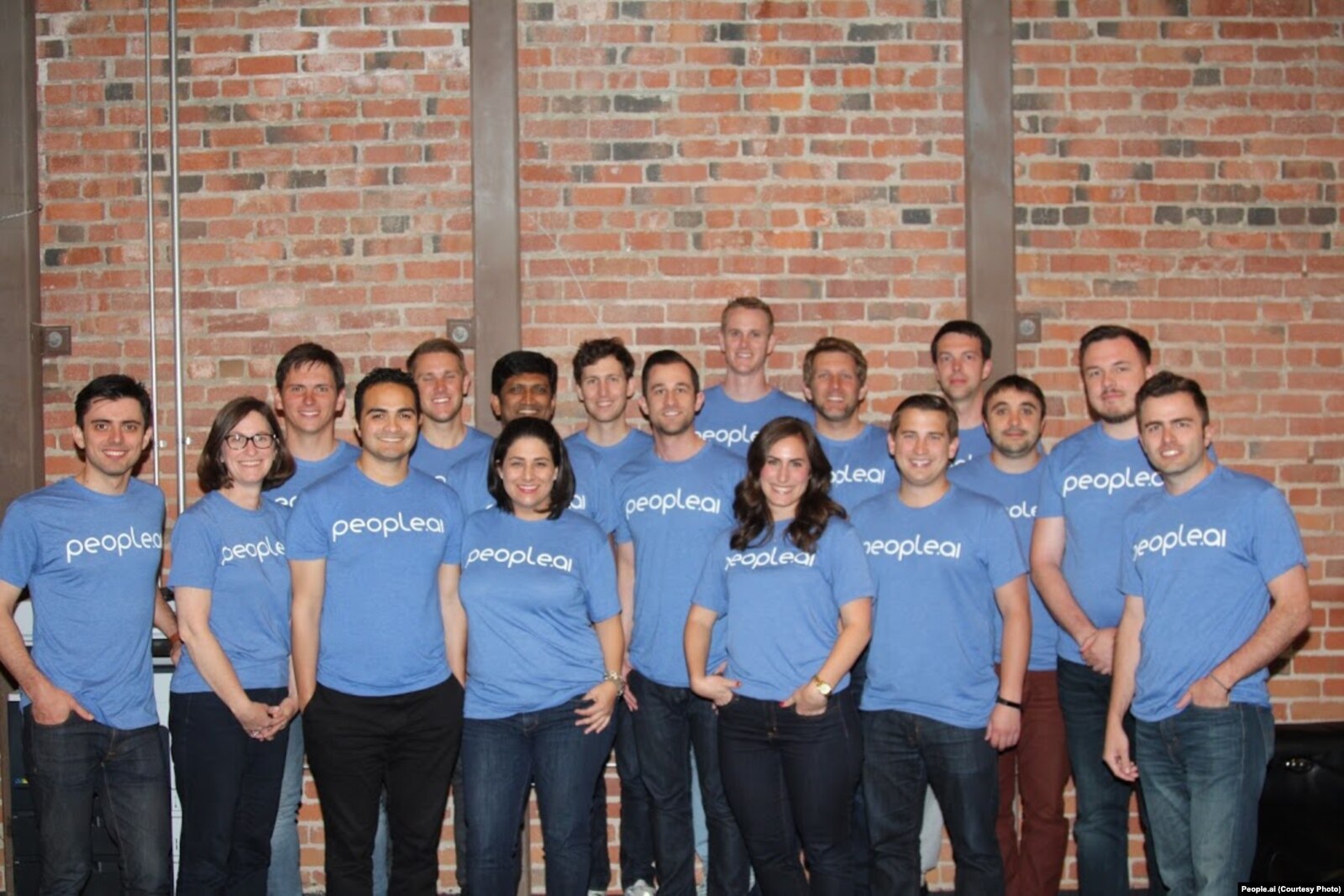 The early People.ai team standing together in blue company T-shirts