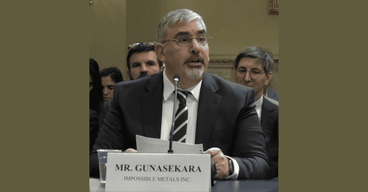 Oliver Gunasekara at a microphone, giving congressional testimony