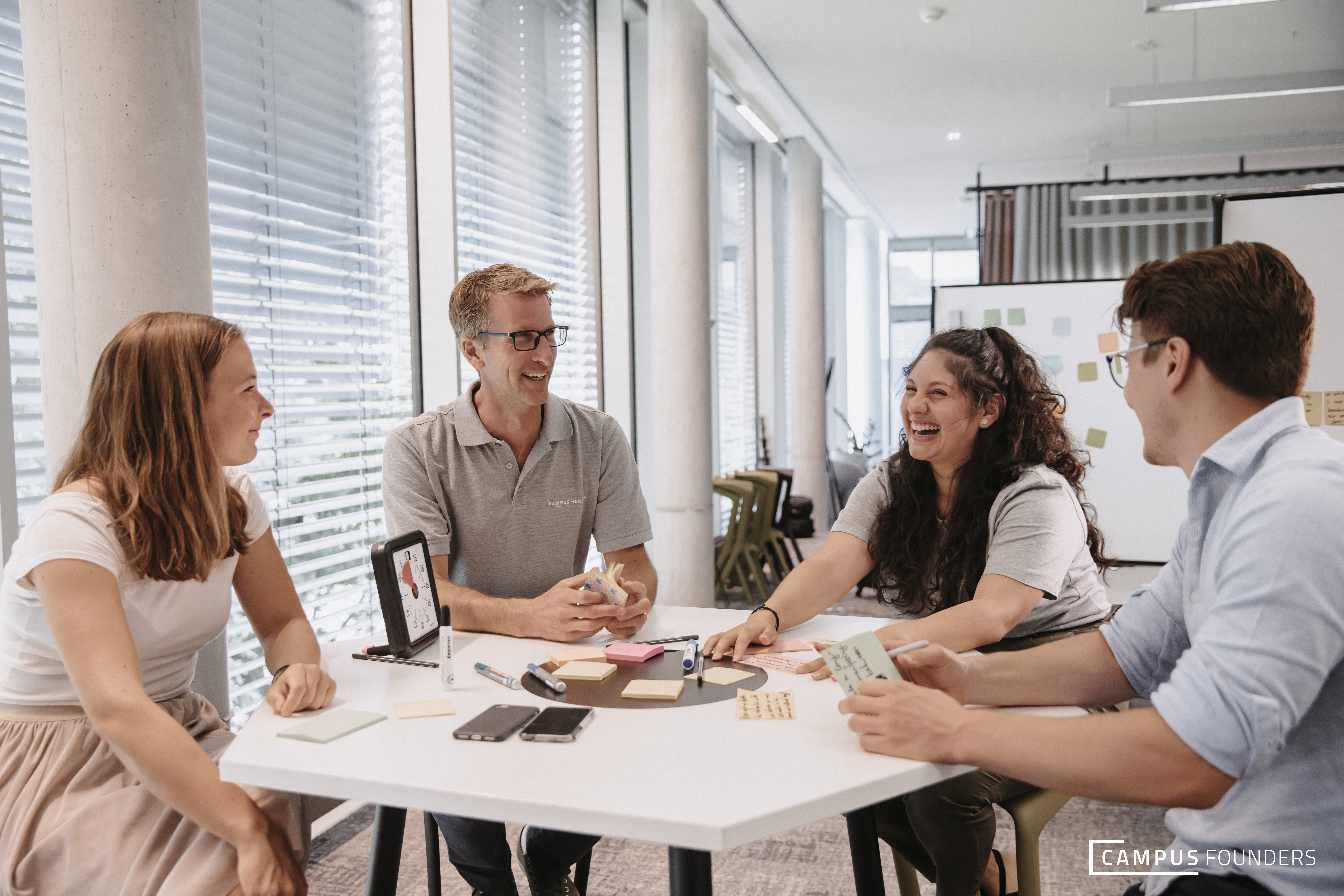 Oliver Hanisch seated at a table with three Campus Founders colleagues