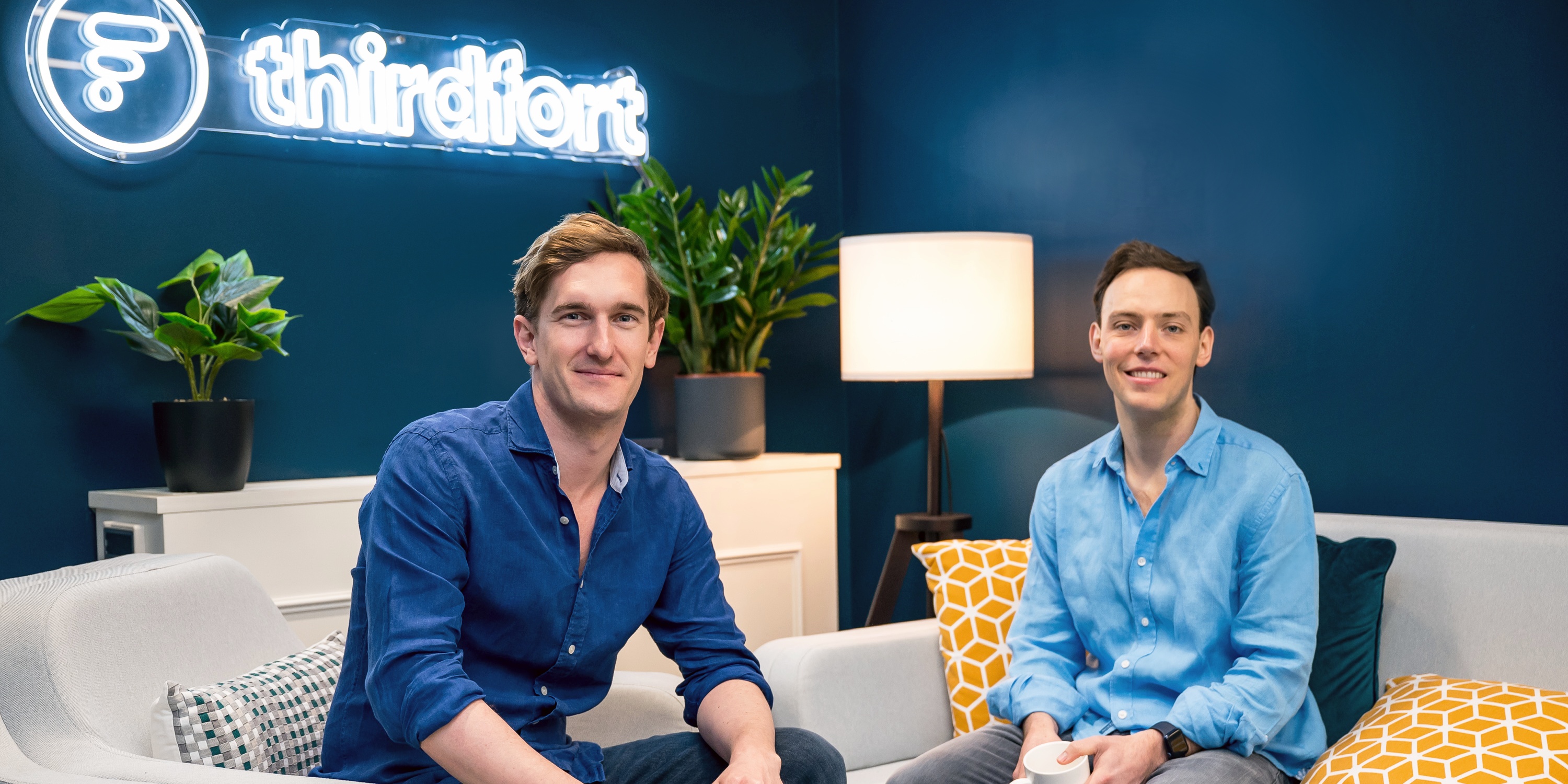 Thirdfort co-founders Jack Bidgood, left, and Olly Thornton-Berry, right, seated in their office