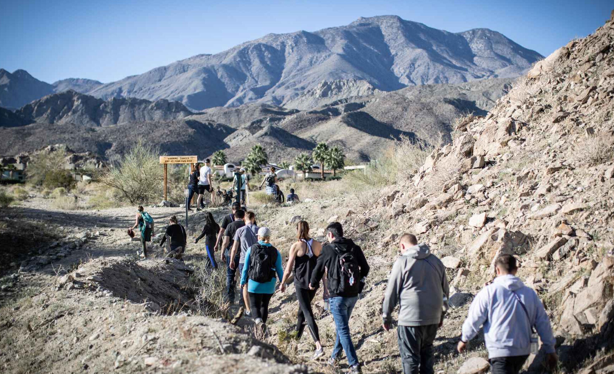 Olo company photograph showing a group hiking on a desert trail