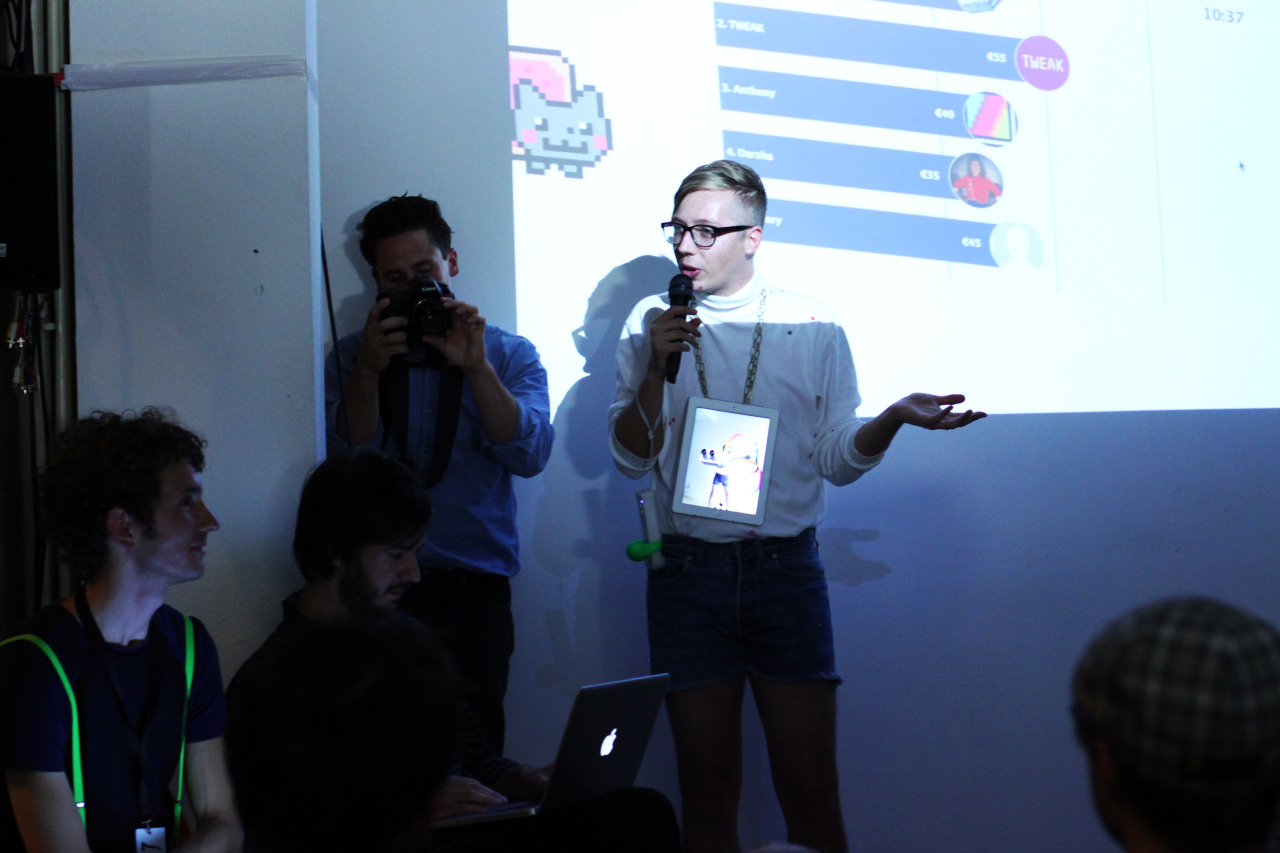 The digital artist auction at Art Hack Day in Berlin, with Mathé seated at the left