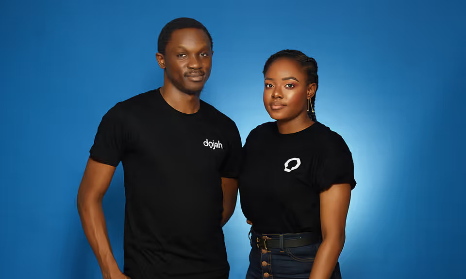 Dojah co-founders Tobi Ololade and Ayomide Oso wearing black company shirts