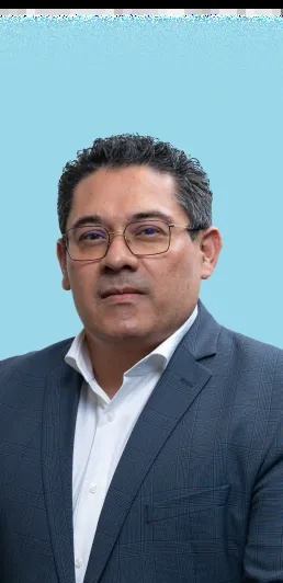 Omar E. Hernandez wearing glasses and a dark checked jacket