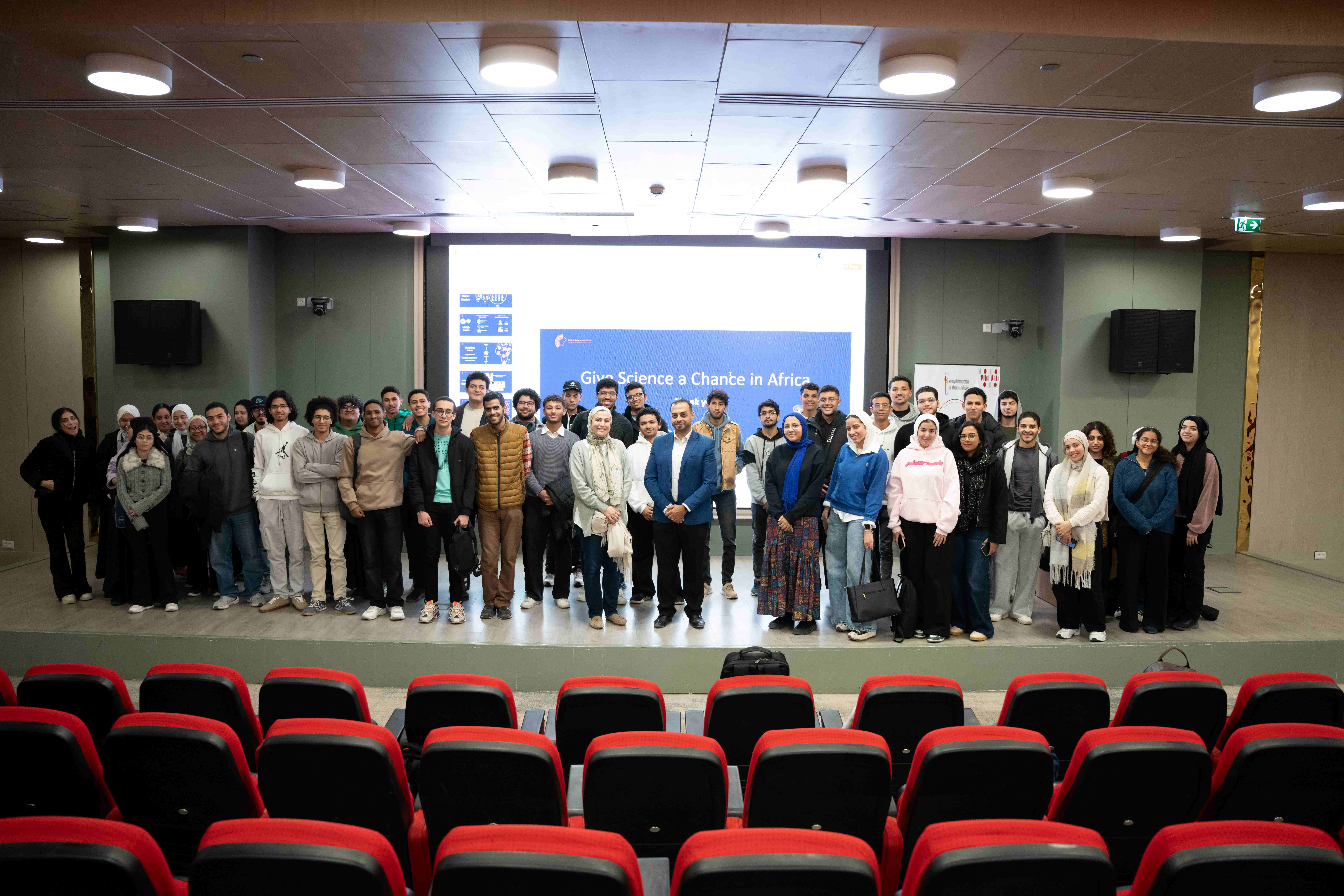 Omar Sakr, in a blue jacket at centre, with students at Egypt University of Informatics