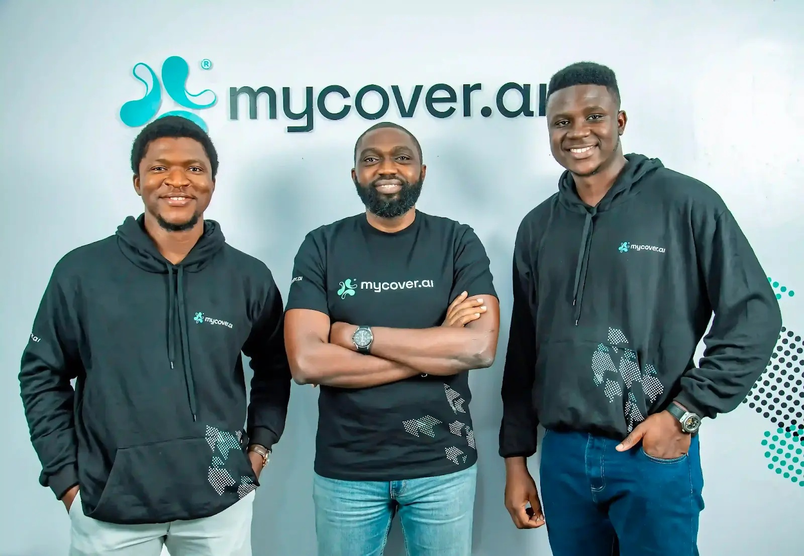 Three MyCover.ai team members standing in front of their company sign