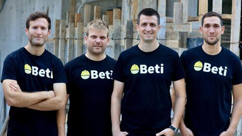 The four Beti founders wearing company shirts at a construction site