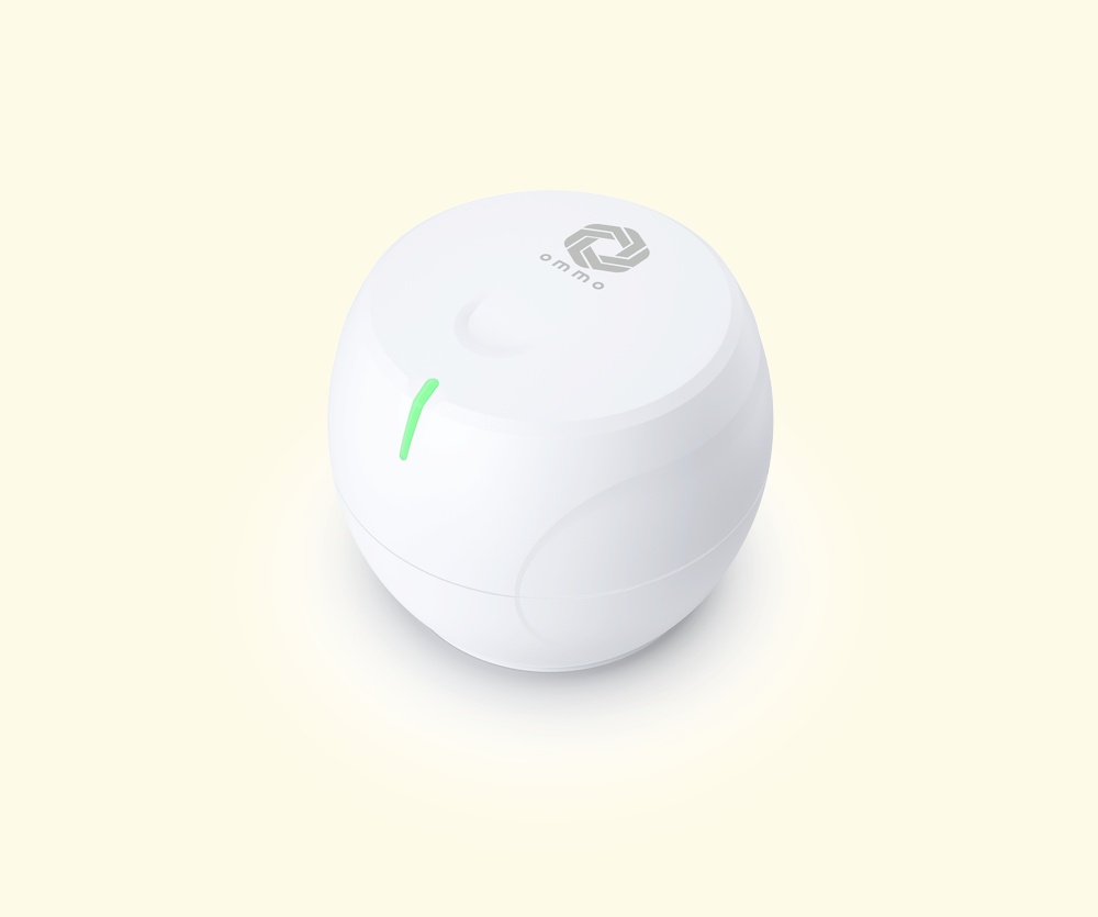 Ommo Orbit base station, a compact white rounded unit with a green indicator