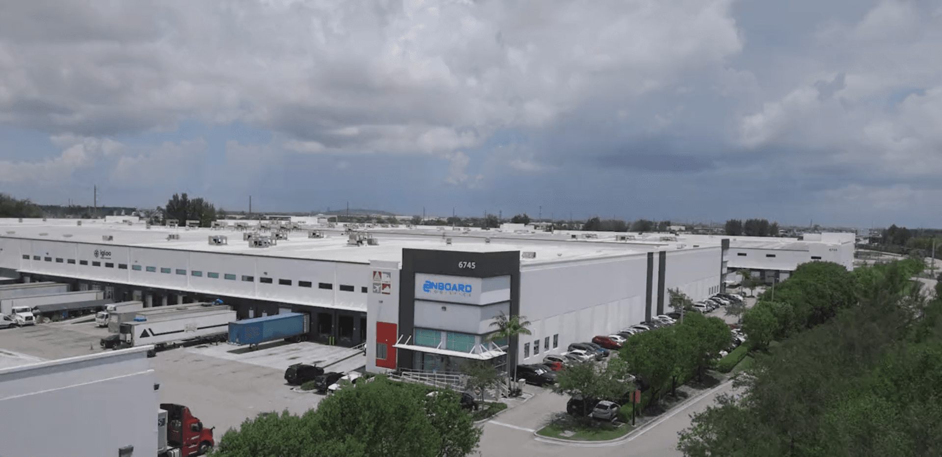 An earlier OnBoard Miami warehouse with loading docks and trucks
